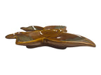 Ceramic leaf-shaped dish with green accents on a white background