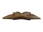 Decorative butterfly-shaped object with a metallic finish on a white background