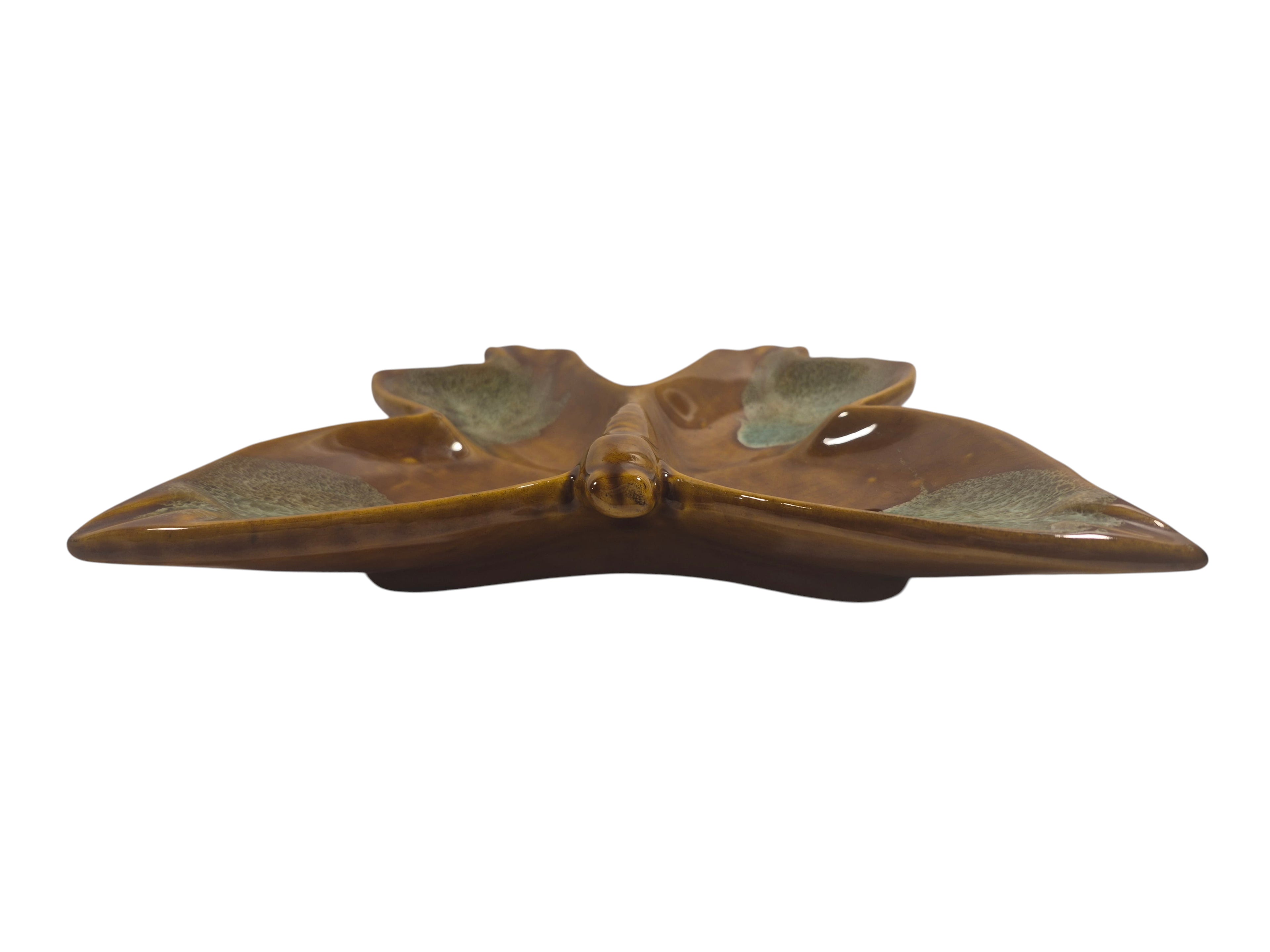 Decorative butterfly-shaped object with a metallic finish on a white background