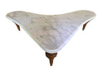 Vintage biomorphic white marble coffee table with carved walnut-toned wood legs and brass foot caps.