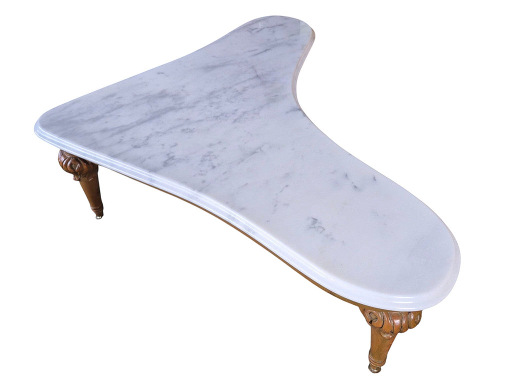 Vintage biomorphic white marble coffee table with carved walnut-toned wood legs and brass foot caps.