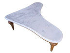 Vintage biomorphic white marble coffee table with carved walnut-toned wood legs and brass foot caps.