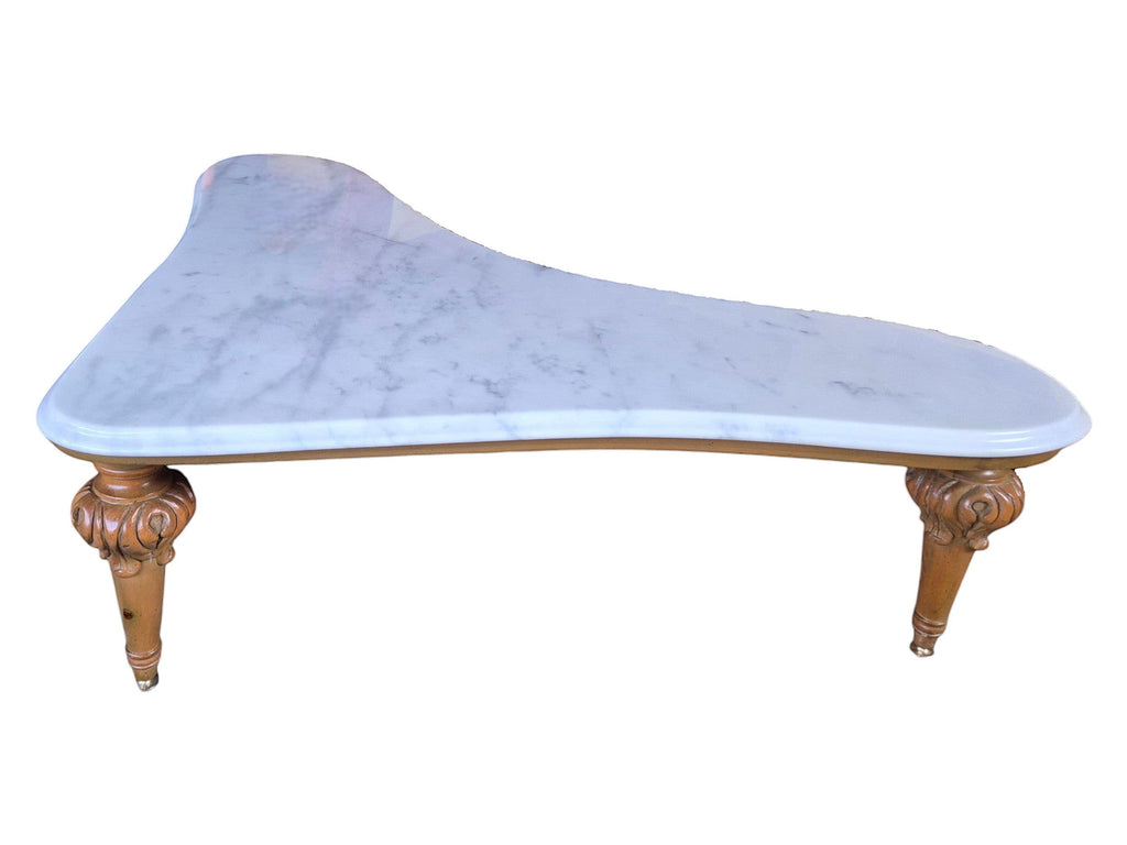 Vintage biomorphic white marble coffee table with carved walnut-toned wood legs and brass foot caps.