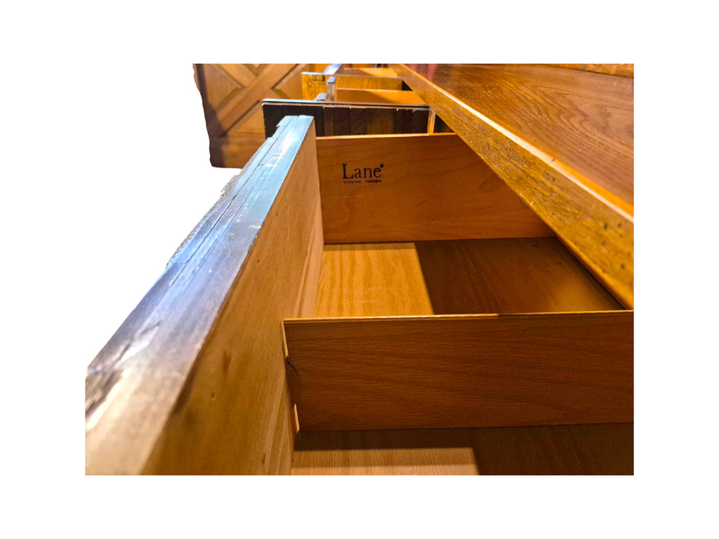 A vintage mid-century modern Lane Pueblo oak credenza featuring Brutalist geometric carved wood drawer fronts. Displays the Lane marking of authenticity in the front top left drawer.