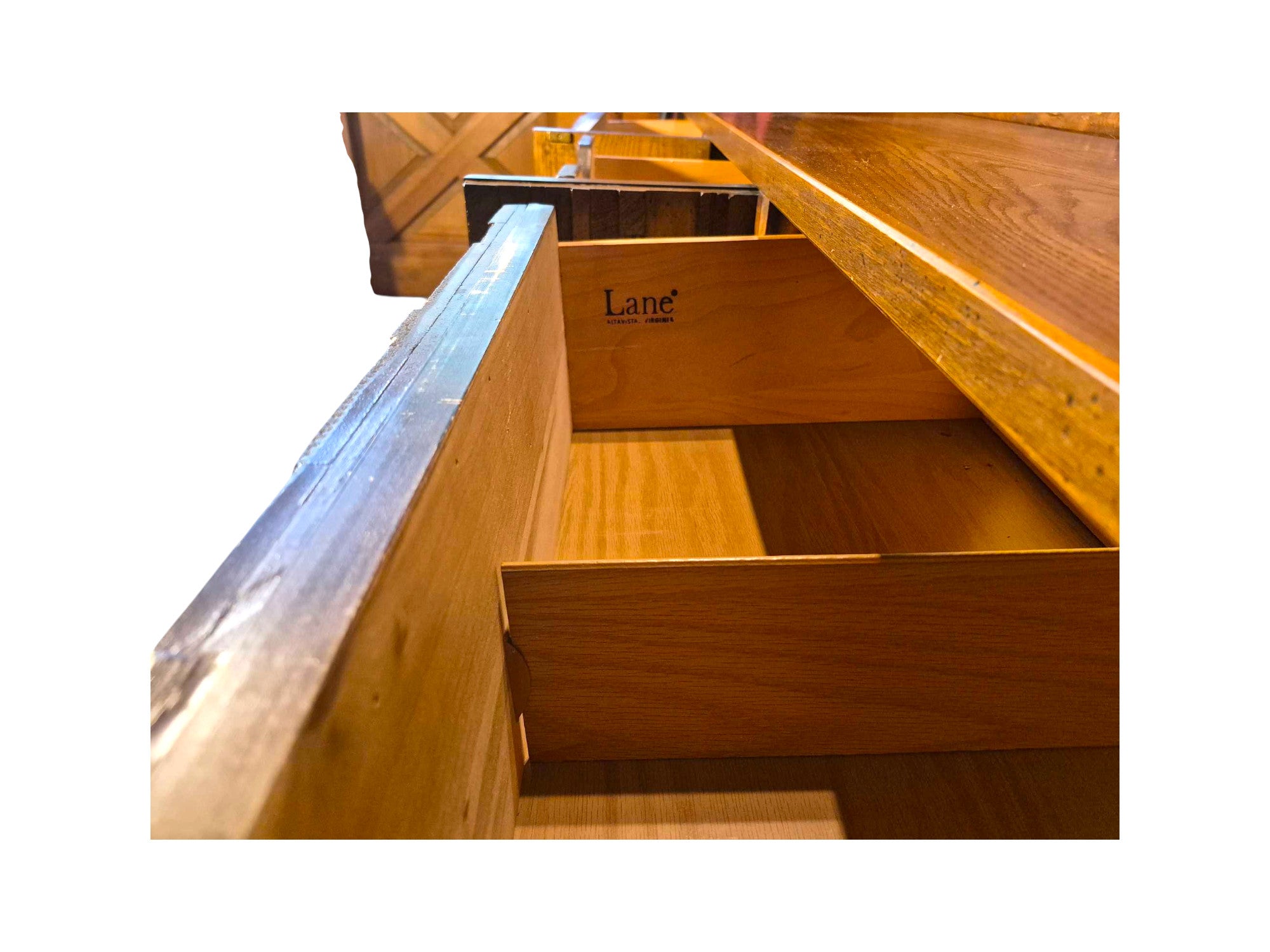 A vintage mid-century modern Lane Pueblo oak credenza featuring Brutalist geometric carved wood drawer fronts. Displays the Lane marking of authenticity in the front top left drawer.