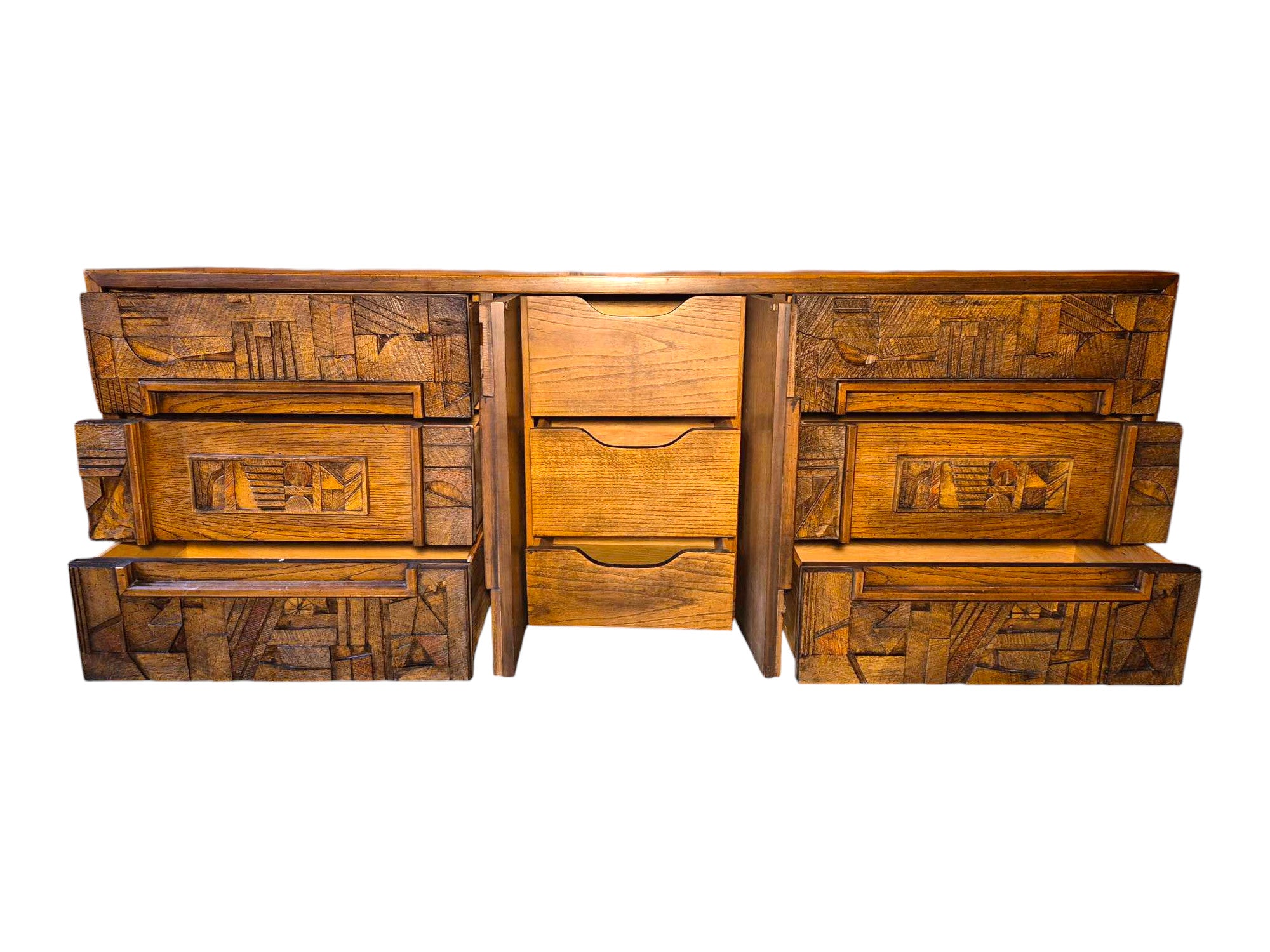 Front view of a vintage mid-century modern Lane Pueblo oak credenza featuring Brutalist geometric carved wood drawer fronts.