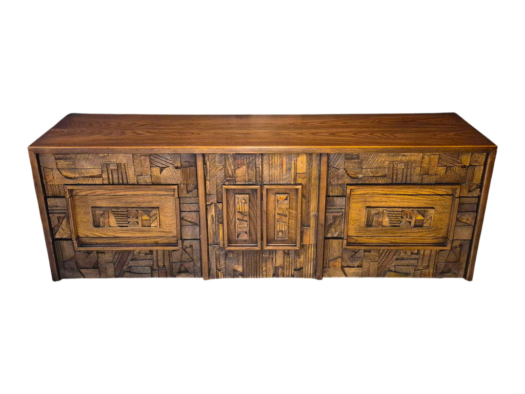 A vintage mid-century modern Lane Pueblo oak credenza featuring Brutalist geometric carved wood drawer fronts.