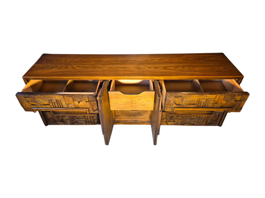 A vintage mid-century modern Lane Pueblo oak credenza featuring Brutalist geometric carved wood drawer fronts.