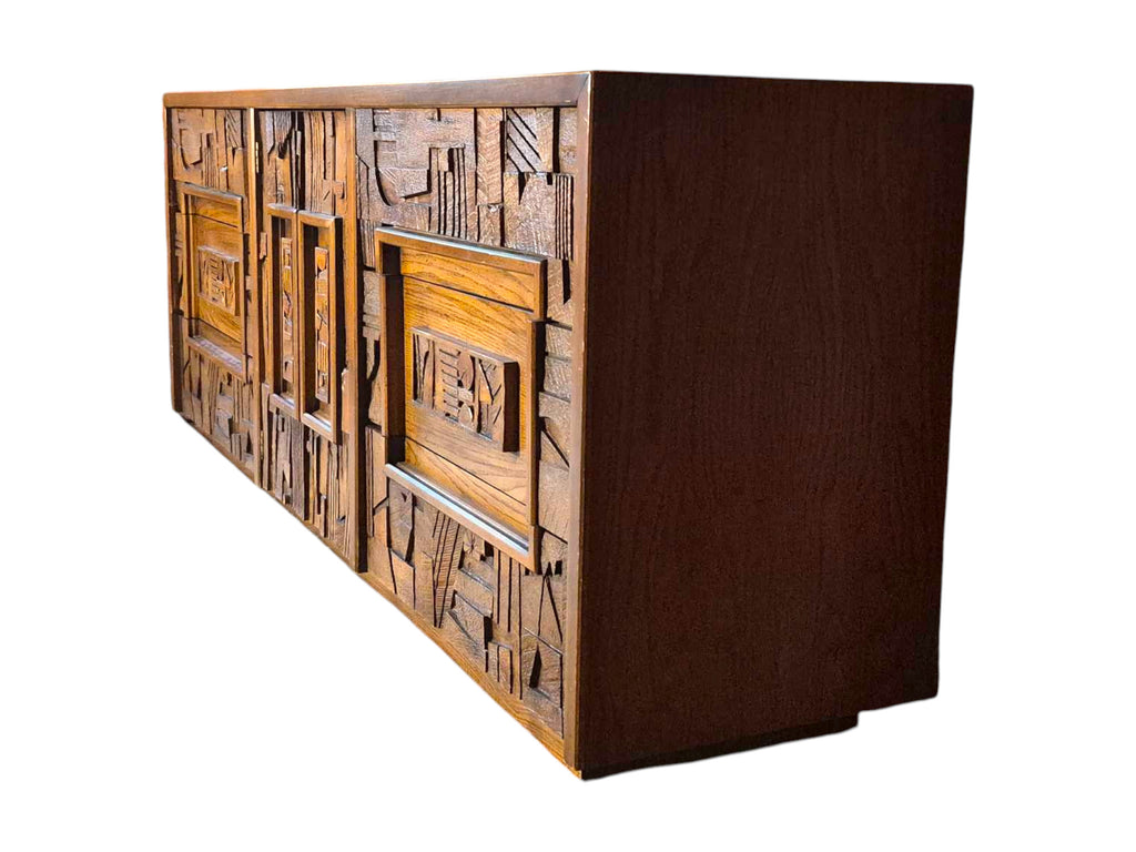 A vintage mid-century modern Lane Pueblo oak credenza featuring Brutalist geometric carved wood drawer fronts.