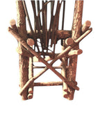 Vintage, handmade rustic twig chair in a low back view featuring tall, branching backrest, slatted branch seat, and cross-braced legs. Made from raw branches with unpeeled bark. Sold vintage as-is in very good condition.
