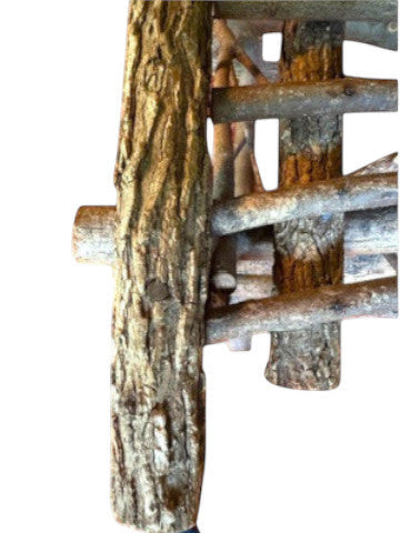 Vintage, handmade rustic twig chair in a close-up detail view featuring tall, branching backrest, slatted branch seat, and cross-braced legs. Made from raw branches with unpeeled bark. Sold vintage as-is in very good condition.