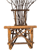 Vintage, handmade rustic twig chair in a low front view featuring tall, branching backrest, slatted branch seat, and cross-braced legs. Made from raw branches with unpeeled bark. Sold vintage as-is in very good condition.