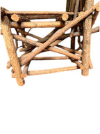 Vintage, handmade rustic twig chair in a low left profile view featuring tall, branching backrest, slatted branch seat, and cross-braced legs. Made from raw branches with unpeeled bark. Sold vintage as-is in very good condition.