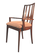 Mid Century Modern Broyhill Brasilia walnut arm dining chair in a left-front view. Features a signature cathedral slatted back and original beige geometric upholstered seat. Vintage as-is, gently refreshed, as part of a set of six.