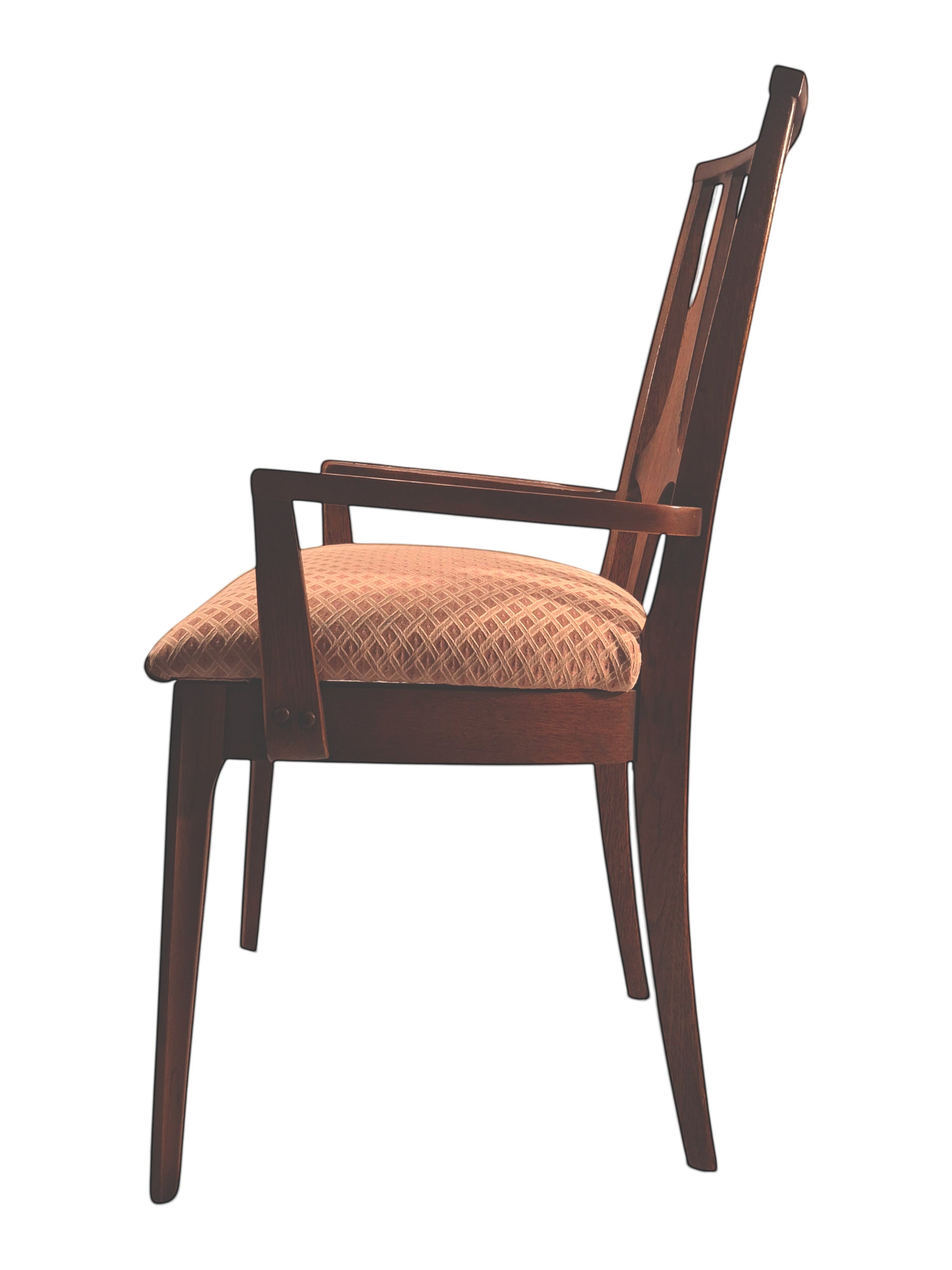 Mid Century Modern Broyhill Brasilia walnut arm dining chair in a left profile view. Features a signature cathedral slatted back and original beige geometric upholstered seat. Vintage as-is, gently refreshed, as part of a set of six.
