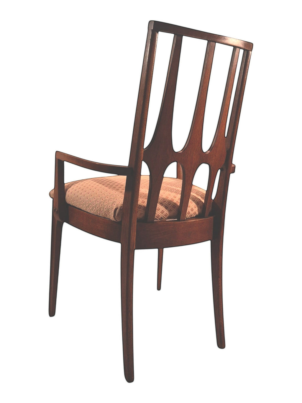 Mid Century Modern Broyhill Brasilia walnut arm dining chair in a back-left view. Features a signature cathedral slatted back and original beige geometric upholstered seat. Vintage as-is, gently refreshed, as part of a set of six.