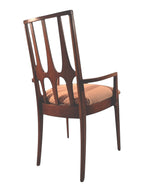 Mid Century Modern Broyhill Brasilia walnut arm dining chair in a back-right view. Features a signature cathedral slatted back and original beige geometric upholstered seat. Vintage as-is, gently refreshed, as part of a set of six.
