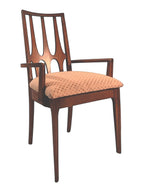 Mid Century Modern Broyhill Brasilia walnut arm dining chair in a three-quarters view. Features a signature cathedral slatted back and original beige geometric upholstered seat. Vintage as-is, gently refreshed, as part of a set of six.