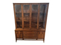 Mid Century Modern Broyhill Brasilia walnut breakfront China cabinet in a front view. Features the Brasilia collection's catseye sweeping arches and tapered legs, with brass hardware and glass display doors. Vintage as-is, gently refreshed, including credenza base with three drawers and two doors and top display deck with two doors.