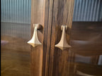 Mid Century Modern Broyhill Brasilia walnut breakfront China cabinet detail shot displaying brass pendant pull hardware on the breakfront doors.