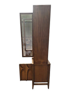 Mid Century Modern Broyhill Brasilia walnut breakfront China cabinet in a left profile view, with open doors and drawers. Features the Brasilia collection's catseye sweeping arches and tapered legs, with brass hardware and glass display doors. Vintage as-is, gently refreshed, including credenza base with three drawers and two doors and top display deck with two doors.