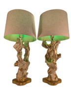 Vintage 1950s mid-century modern sculptural table lamp made of chalkware plaster, shaped like twisted biomorphic driftwood featuring a white gesso finish with hand-painted gold leaf highlights, sitting on a scalloped gold base against a white backdrop.