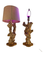 Vintage 1950s mid-century modern sculptural table lamp made of chalkware plaster, shaped like twisted biomorphic driftwood featuring a white gesso finish with hand-painted gold leaf highlights, sitting on a scalloped gold base against a white backdrop.