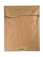 Back view of Curated Vintage Design framed charcoal drawing showing brown paper backing and wire hanging hardware