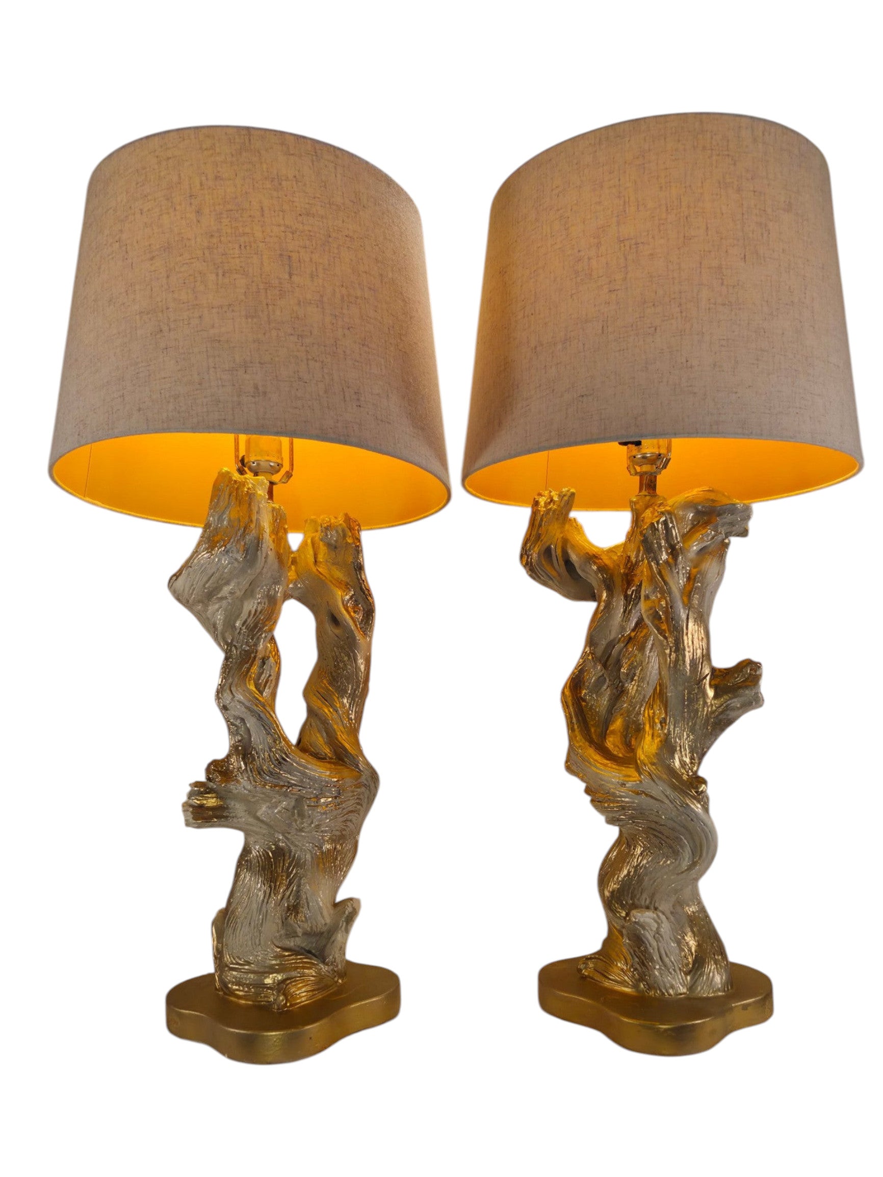 Vintage 1950s mid-century modern sculptural table lamp made of chalkware plaster, shaped like twisted biomorphic driftwood featuring a white gesso finish with hand-painted gold leaf highlights, sitting on a scalloped gold base against a white backdrop.