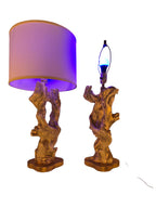 Vintage 1950s mid-century modern sculptural table lamp made of chalkware plaster, shaped like twisted biomorphic driftwood featuring a white gesso finish with hand-painted gold leaf highlights, sitting on a scalloped gold base against a white backdrop.