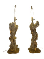 Vintage 1950s mid-century modern sculptural table lamp made of chalkware plaster, shaped like twisted biomorphic driftwood featuring a white gesso finish with hand-painted gold leaf highlights, sitting on a scalloped gold base against a white backdrop.