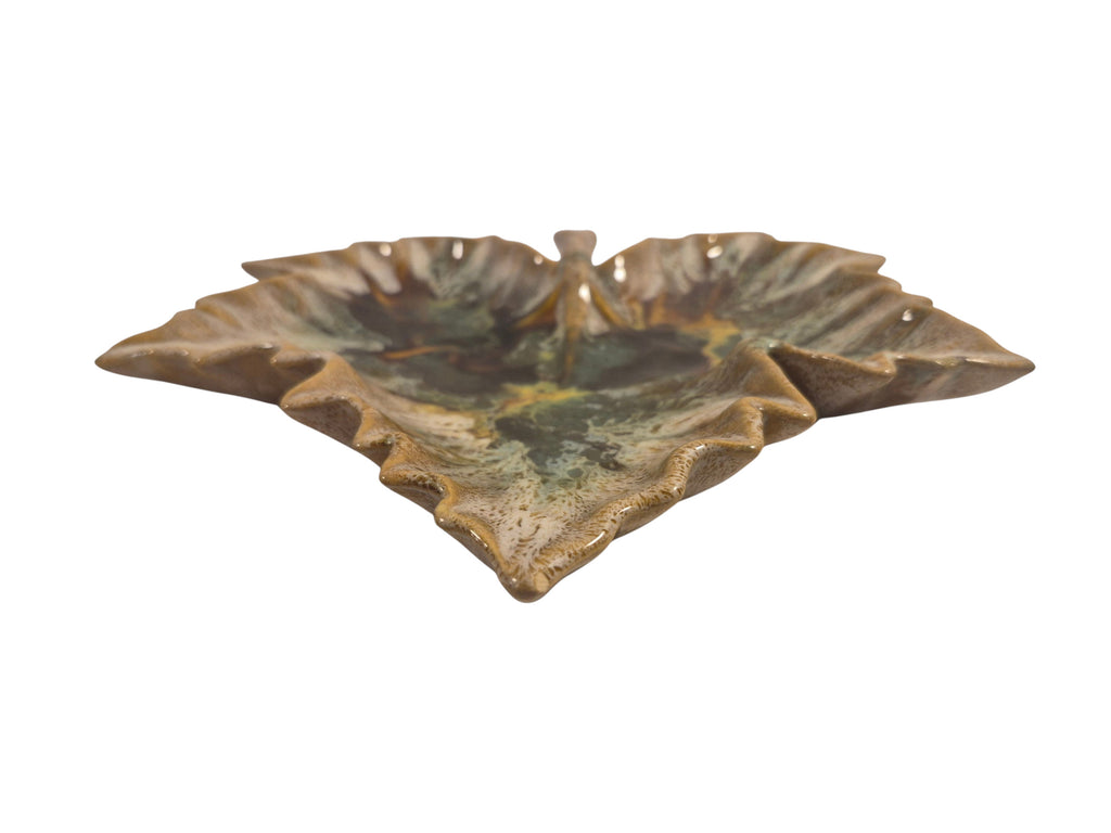 Curated Vintage Design leaf-shaped ceramic dish with multi-tonal green, brown, and yellow glaze. Decorative accent.