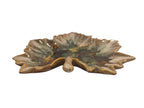 Curated Vintage Design leaf-shaped ceramic dish with multi-tonal green, brown, and yellow glaze. Features raised edges and a glossy finish.