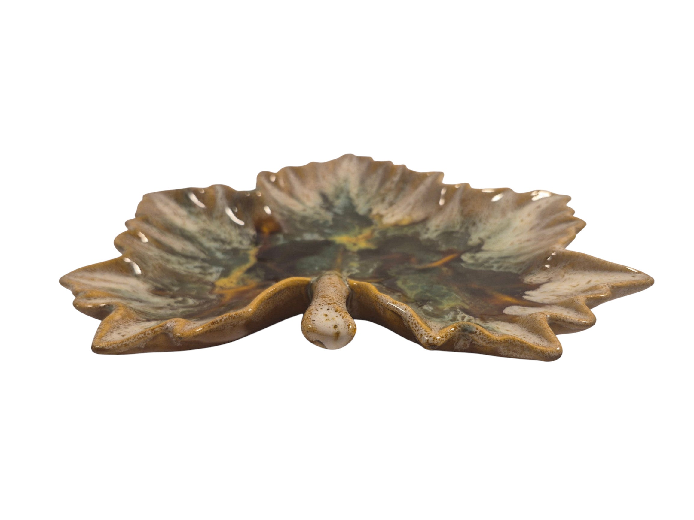 Curated Vintage Design leaf-shaped ceramic dish with multi-tonal green, brown, and yellow glaze. Features raised edges and a glossy finish.